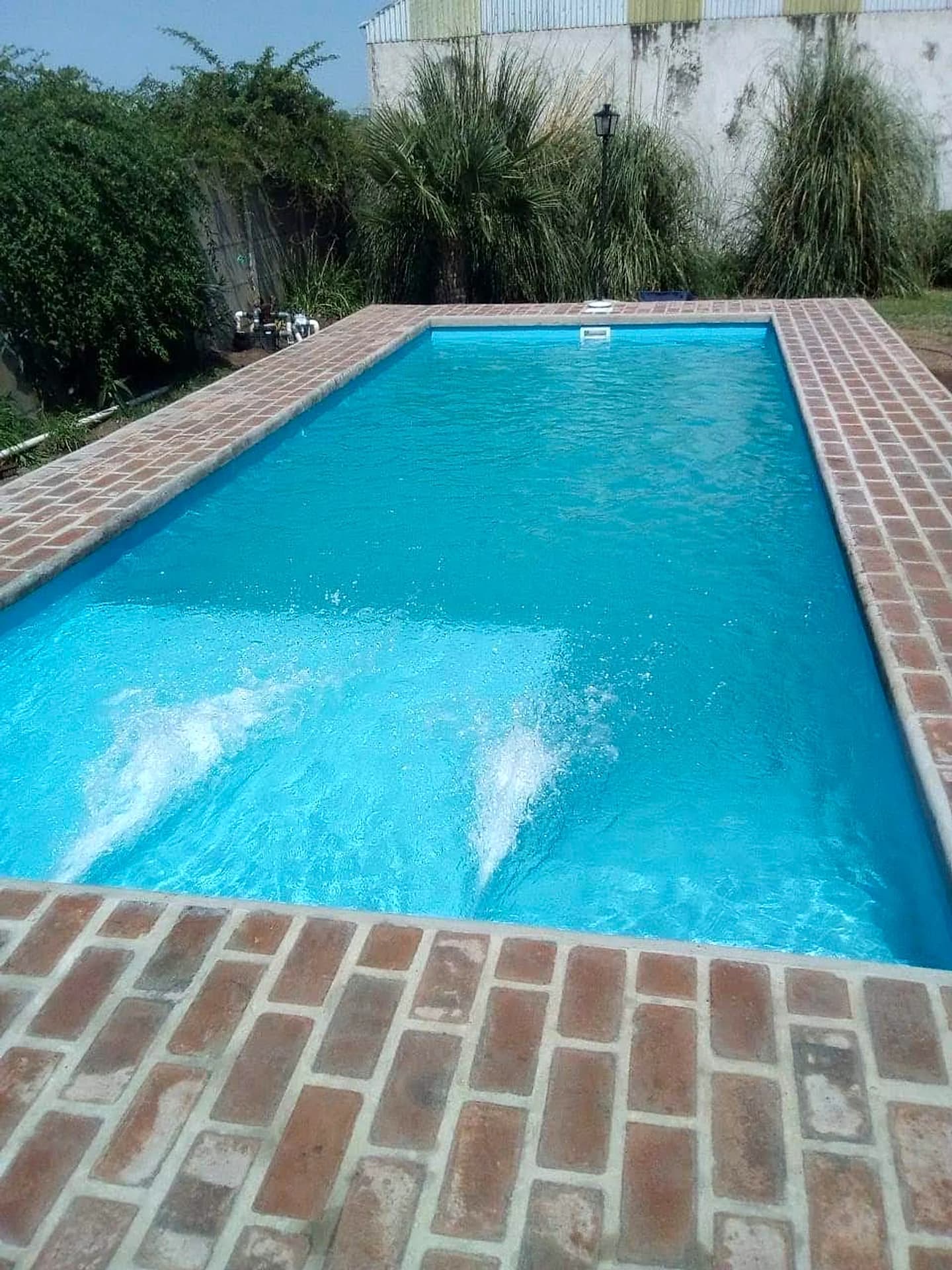 Piscina rústica con coronamiento en ladrillo colonial